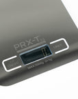 A close-up of a compact digital scale with the PRX Derm Perfexion logo